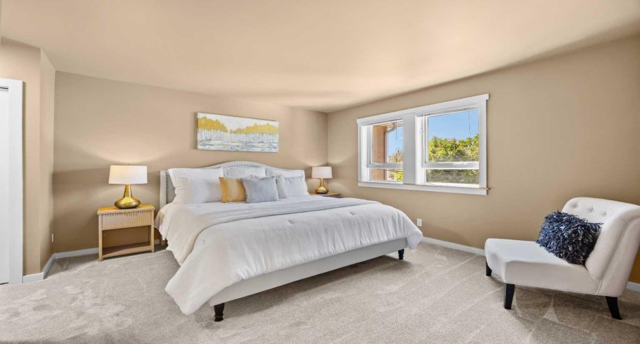 A soft and warm palette make the primary bedroom feel like a true retreat.
