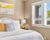 Another view of the primary bedroom highlights the warm lighting and calm, restful atmosphere throughout the space.