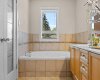 The tub's tiled surround and window view add a spa-like touch to the primary ensuite.