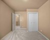 A second upper-level bedroom offers double closet doors and easy access to the hallway.