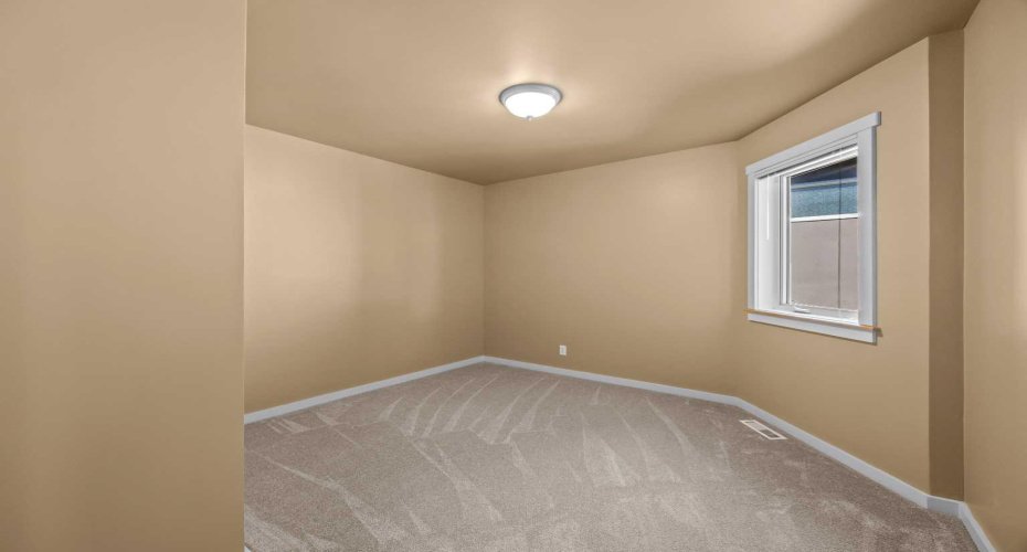 This upper-level bedroom brings in plenty of natural light through its window.
