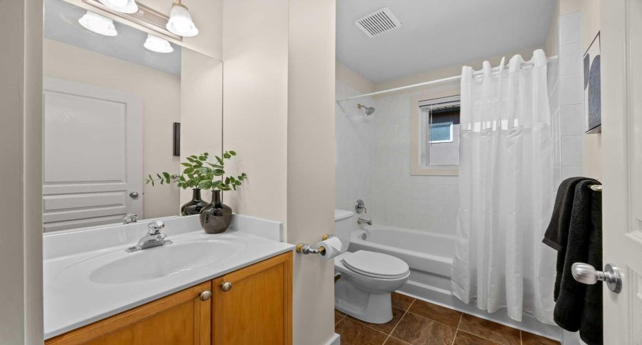 A well-appointed upper-level bathroom serves the additional bedrooms with a walk-in shower and tub combo.