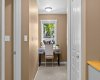 A charming study nook on the upper level offers a bright spot to work or read, overlooking the tree-canopied street.