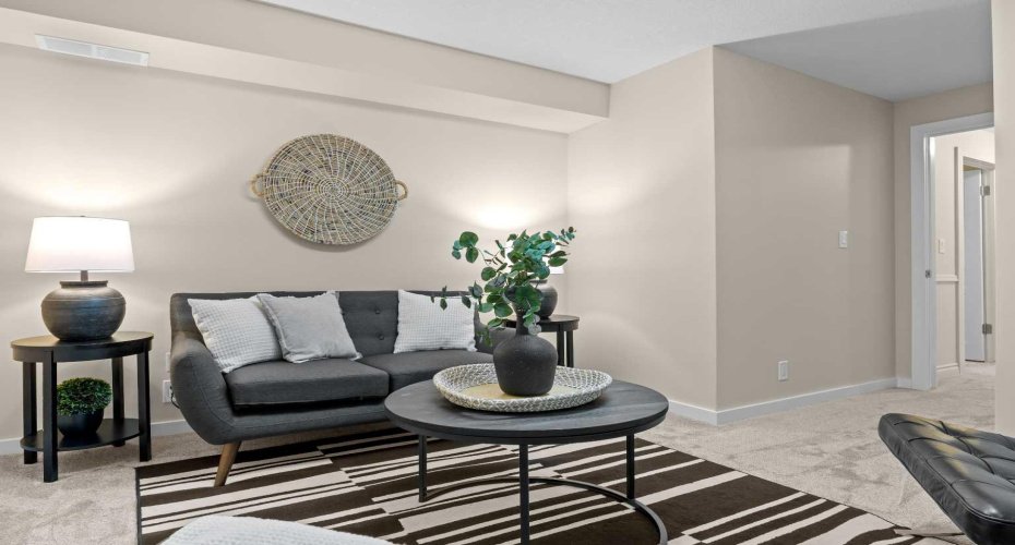 This lower-level bedroom's cozy seating area suits movie nights just as well as overnight guests.