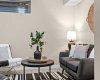 Another view shows how easily this lower-level bedroom flows into a relaxed bonus or TV room setup.