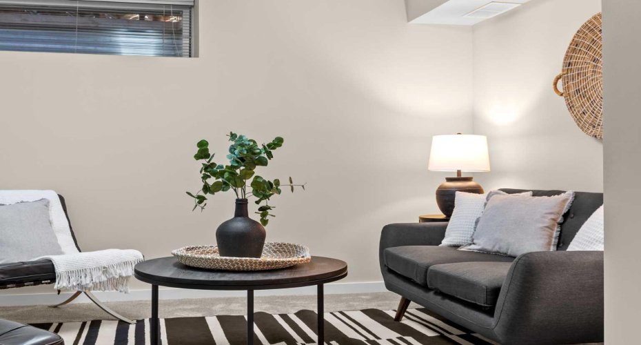 Another view shows how easily this lower-level bedroom flows into a relaxed bonus or TV room setup.