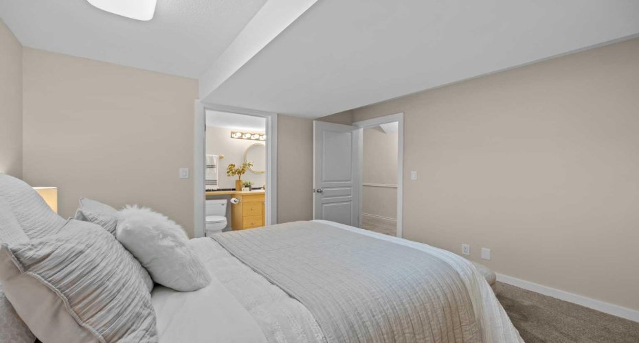 A lower-level bedroom connects directly to a private ensuite, adding convenience for guests or family.