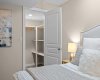 A generous walk-in closet offers custom shelving right off the second bedroom.