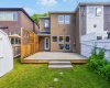 A full view of the back of the home shows the deck's flow into the yard.