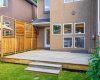 A closer look at the back entry and deck highlights the home's clean, and modern lines.