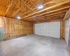 The spacious garage interior shows ample room for two vehicles, lots of room to park a 1/2 ton truck, plus space for storage and workshop use.