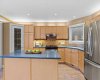 Abundant cabinetry and counter space make this kitchen as practical as it is inviting, with a stainless fridge and gas range at the ready.