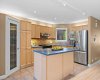 The kitchen island offers extra prep space and a natural gathering spot, just steps from the pantry and fridge.