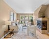 The living room centers on a warm gas fireplace, with plenty of natural light and room to unwind.
