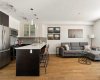 Kitchen w/ breakfast bar, overlooking living area