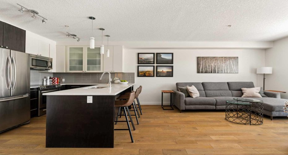 Kitchen w/ breakfast bar, overlooking living area