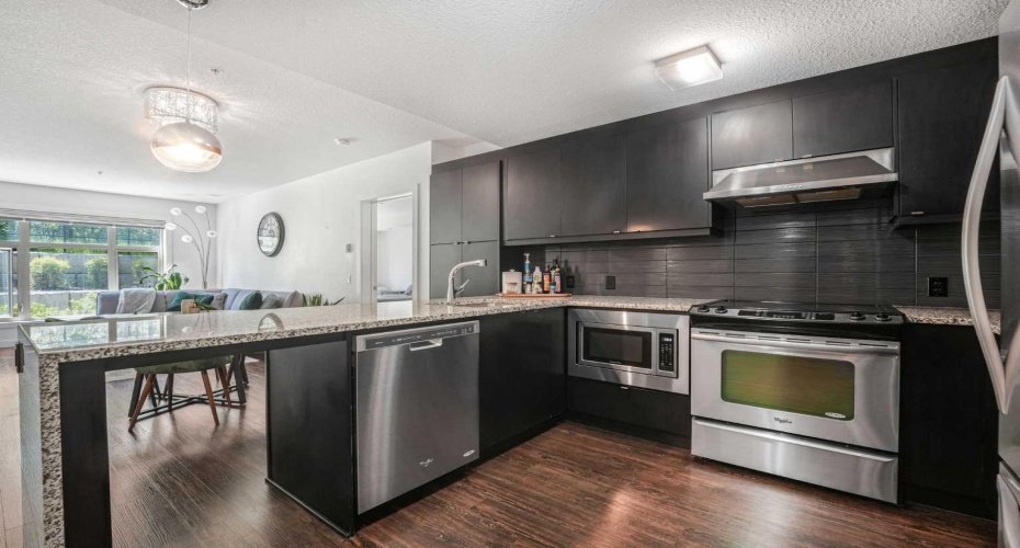 Notice the ceiling height cabinets, ample counter space, and extra stool area.