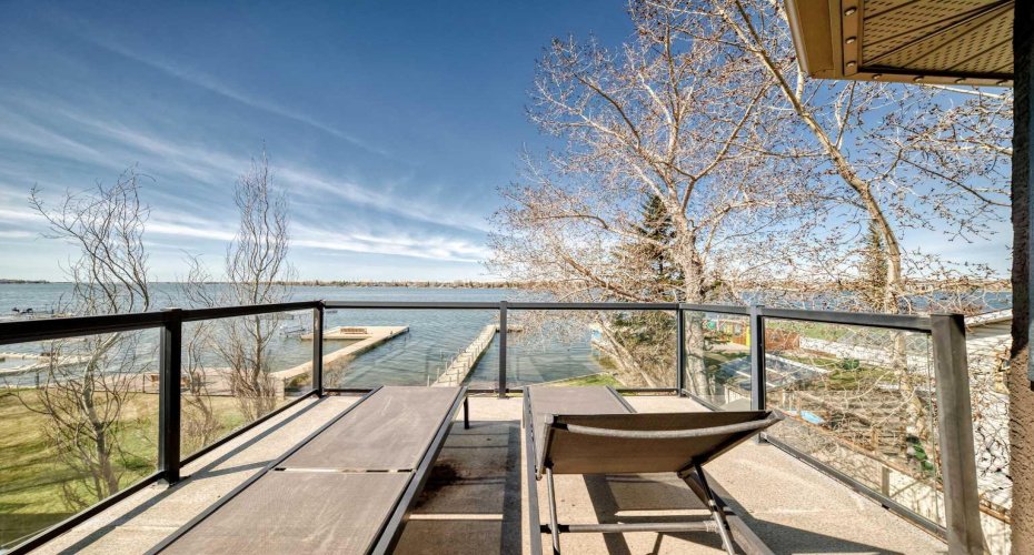 The primary bedroom offers direct access to a private deck overlooking the lake!