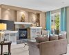 Tall windows and flowing drapery bathe the living room in natural light while framing views of the private backyard. Tall windows and flowing drapery bathe the living room in natural light while framing views of the private backyard.
