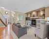 The open concept main floor flows effortlessly from the foyer into a bright living room centered on a stone faced fireplace. The open concept main floor flows effortlessly from the foyer into a bright living room centered on a stone faced fireplace.