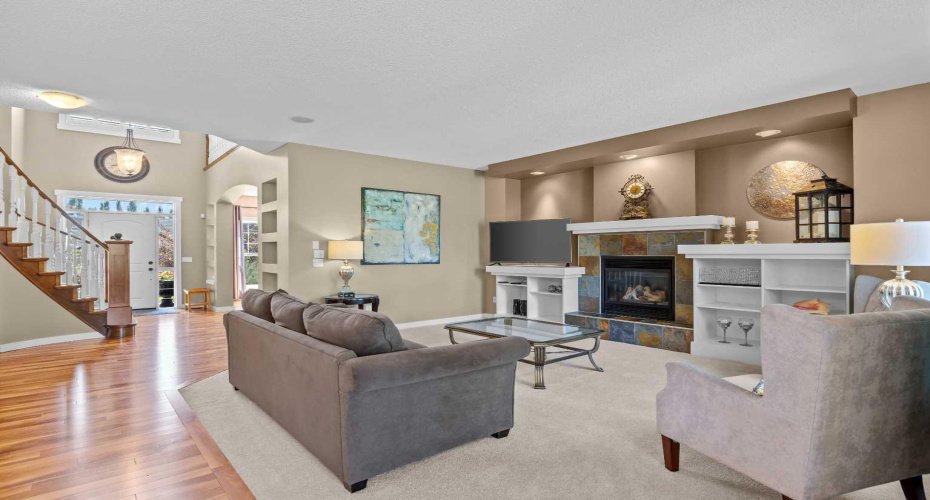The open concept main floor flows effortlessly from the foyer into a bright living room centered on a stone faced fireplace. The open concept main floor flows effortlessly from the foyer into a bright living room centered on a stone faced fireplace.