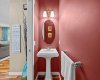 A stylish powder room on the main floor makes a bold statement with rich color and a pedestal sink, perfect for guests. A stylish powder room on the main floor makes a bold statement with rich color and a pedestal sink, perfect for guests.