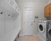 A functional laundry and mudroom combination offers built in storage and direct access to the outdoors. A functional laundry and mudroom combination offers built in storage and direct access to the outdoors.