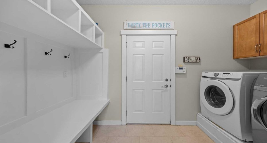 A functional laundry and mudroom combination offers built in storage and direct access to the outdoors. A functional laundry and mudroom combination offers built in storage and direct access to the outdoors.