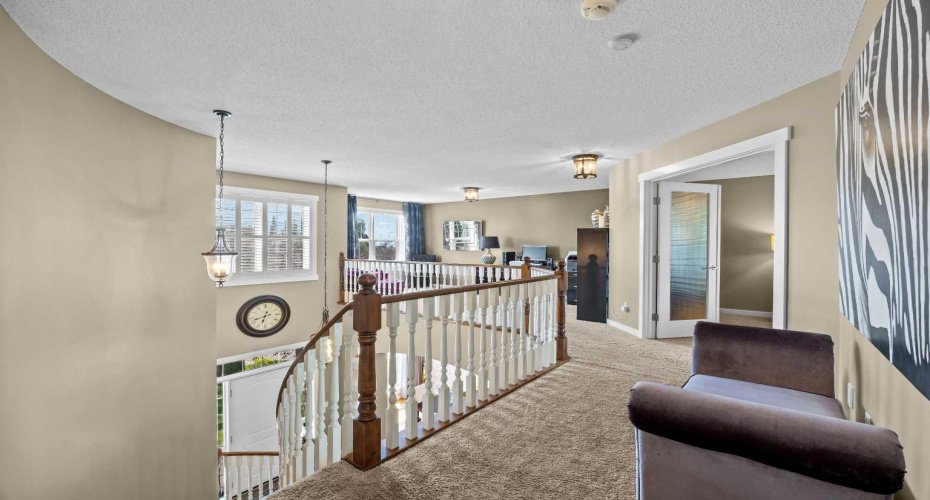 A bright upper level landing overlooks the staircase below and opens onto a versatile loft space, ideal for a home office or reading nook. A bright upper level landing overlooks the staircase below and opens onto a versatile loft space, ideal for a home office or reading nook.