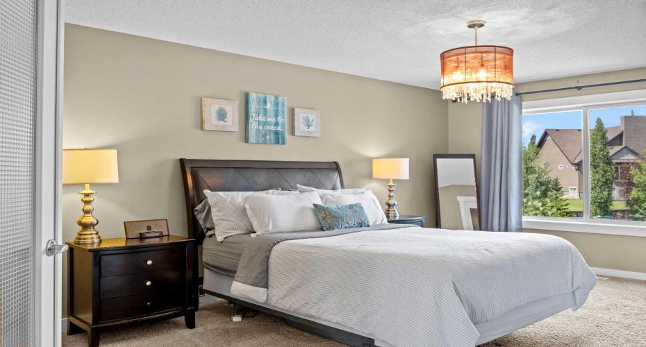 Soft tones and thoughtful lighting create a calm, restful atmosphere in the generously sized primary bedroom. Soft tones and thoughtful lighting create a calm, restful atmosphere in the generously sized primary bedroom.