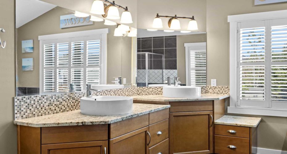 Dual vessel sinks and granite countertops bring a spa like elegance to the ensuite vanity. Dual vessel sinks and granite countertops bring a spa like elegance to the ensuite vanity.