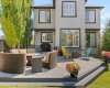 By day, the sprawling deck reveals its full scale, with room for lounging, dining and gathering around the fire table. By day, the sprawling deck reveals its full scale, with room for lounging, dining and gathering around the fire table.