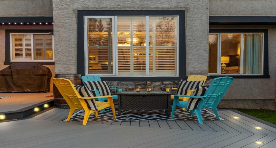 Pops of color from the Adirondack chairs add personality to this inviting corner of the deck. Pops of color from the Adirondack chairs add personality to this inviting corner of the deck.