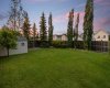 The expansive backyard stretches out beneath a twilight sky, underscoring the sheer size of this exceptional lot. The expansive backyard stretches out beneath a twilight sky, underscoring the sheer size of this exceptional lot.