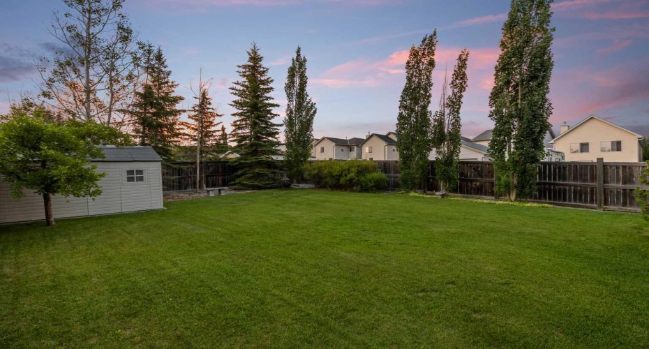 The expansive backyard stretches out beneath a twilight sky, underscoring the sheer size of this exceptional lot. The expansive backyard stretches out beneath a twilight sky, underscoring the sheer size of this exceptional lot.