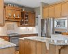 Stainless steel appliances, including a built in wall oven and microwave, complete this thoughtfully designed kitchen. Stainless steel appliances, including a built in wall oven and microwave, complete this thoughtfully designed kitchen.