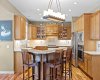 Glass front cabinetry and a raised eating bar add both charm and everyday functionality to this well appointed kitchen. Glass front cabinetry and a raised eating bar add both charm and everyday functionality to this well appointed kitchen.