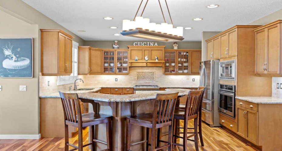 Glass front cabinetry and a raised eating bar add both charm and everyday functionality to this well appointed kitchen. Glass front cabinetry and a raised eating bar add both charm and everyday functionality to this well appointed kitchen.