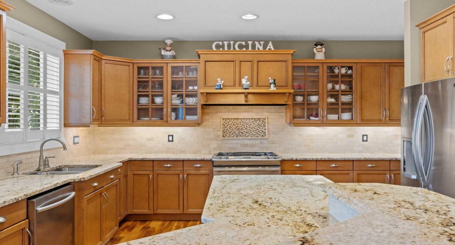 A gas range and abundant cabinetry make this kitchen a true chef's dream, finished with warm granite countertops throughout. A gas range and abundant cabinetry make this kitchen a true chef's dream, finished with warm granite countertops throughout.