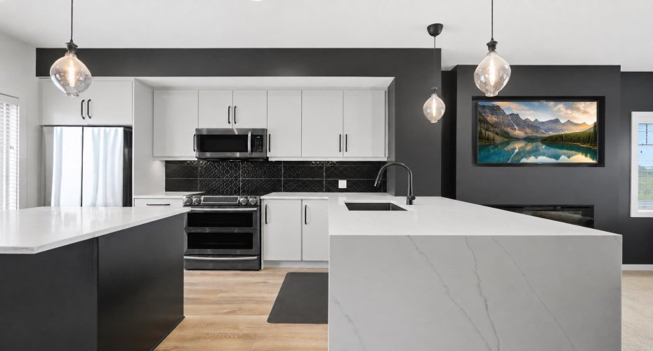 Full-height cabinetry & a quartz countertop with a waterfall edge