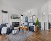 Spacious living room with upgraded railings and cozy fireplace