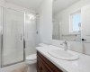 Clean, functional 3 piece ensuite bathroom with rich solid maple shaker cabinets & quarts countertops.