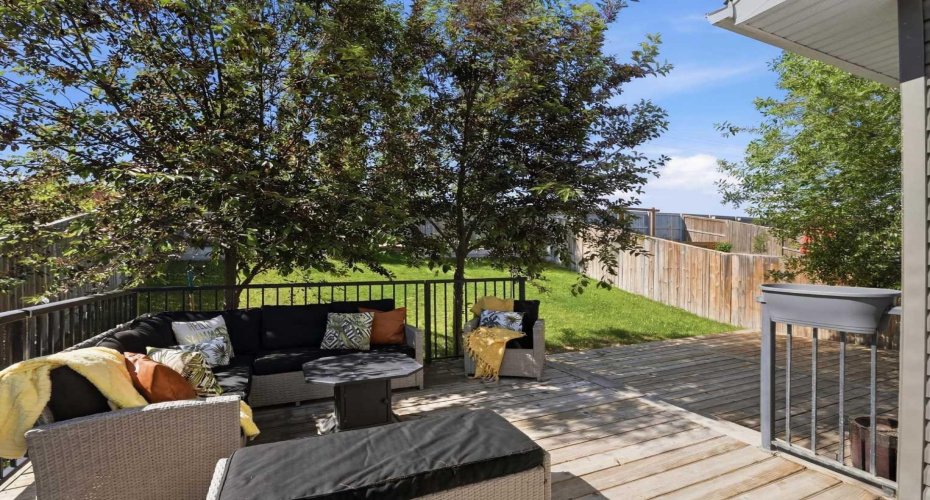 The backyard oasis where you enjoy the 2 tiered deck space, privacy, greenery & lush lawn while you soak up the rays or relax in the shade provided by the mature trees!