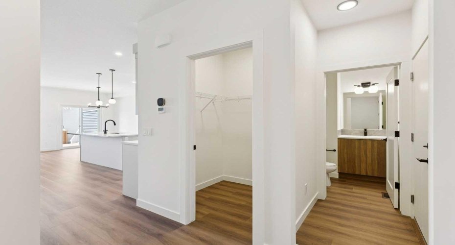 Hallway to Garage Entry, Main Floor Half Bath & Front Entry Walk-in Closet