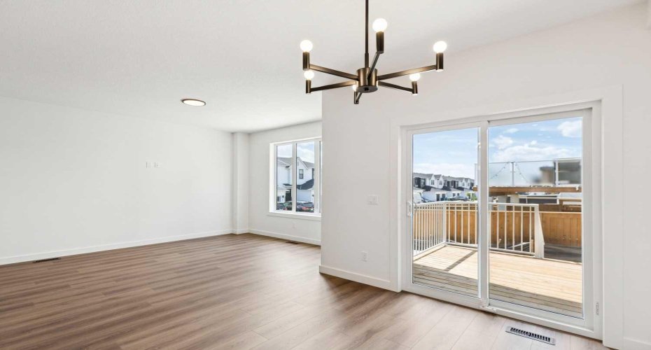 Dining Area w/ Patio Door to Rear Deck and view to Living Room