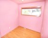 Second bedroom with hardwood floors and mirrored closet doors