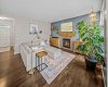 The living room centres around a cozy fireplace with warm wood accents and built in storage.