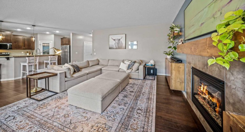 The fireplace creates a warm focal point while the open plan keeps everyone connected.