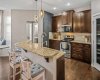 A generous granite island provides extra prep space and casual seating.