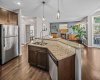 A large island with a raised eating bar adds practical workspace and seating.